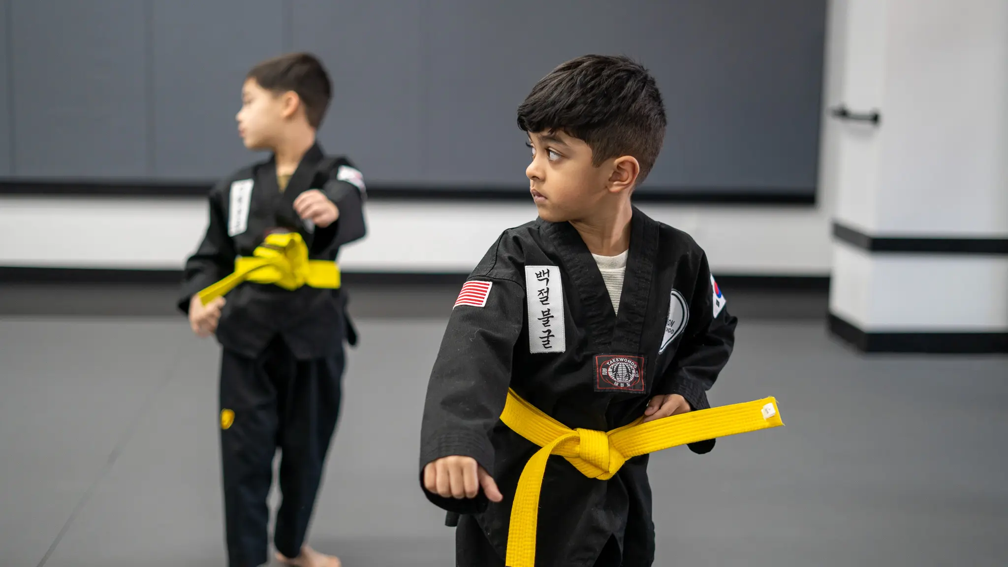Kids martial arts training can practice brazilian jiu-jitsu, muay thai, judo, and taekwondo across multiple locations, enhancing slef-defense skills and physical activity, while students learn techniques to feel safe.
