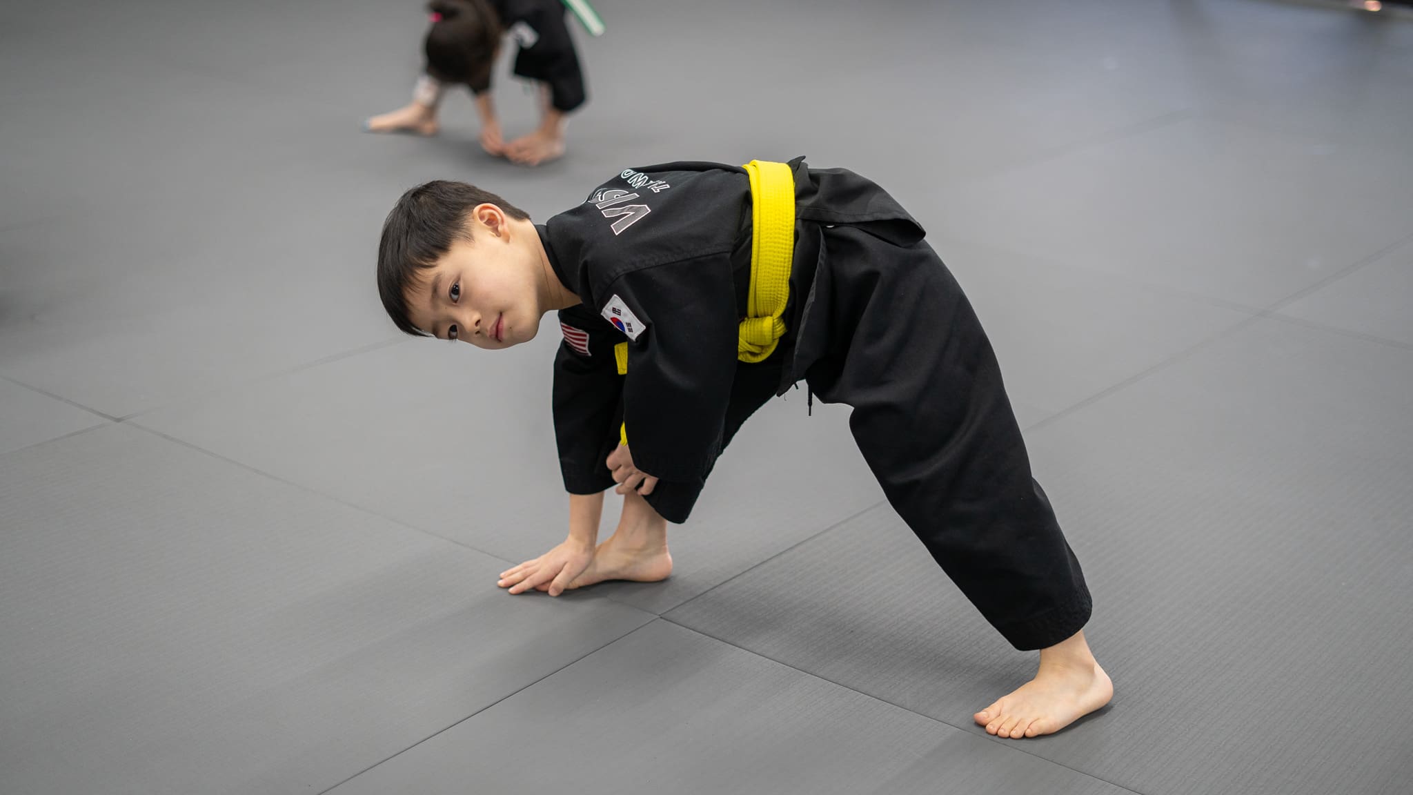 Kids martial arts and self-defense can practice karate and brazilian jiu-jitsu across multiple locations, enhancing coordi nation and skills with warm-up, high-level training, and meditation, leading to overall improvement.