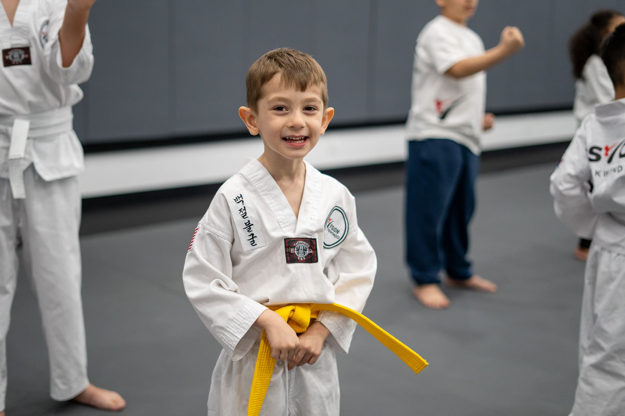 Preschool martial arts training in Taekwondo, a Korean martial art, focuses on self-defense skills, developing self-confidence, gross motor skills, and mental discipline, while experienced instructors guide children in improved fitness, self-discipline, and valuable life skills, all while donning the traditional Taekwondo uniform.