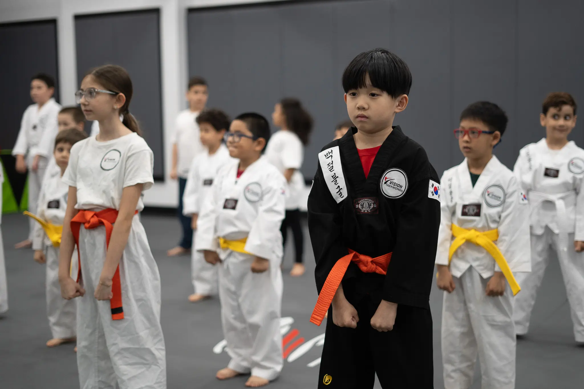 Preschoolers practicing Taekwondo training experience physical benefits, improved motor skills, and stress relief, while learning hand strikes, new techniques, and self-control through the belt system, all within a safe environment using protective gear like shin guards, fostering an appreciation for Korean culture and achieving social benefits with a positive impact.