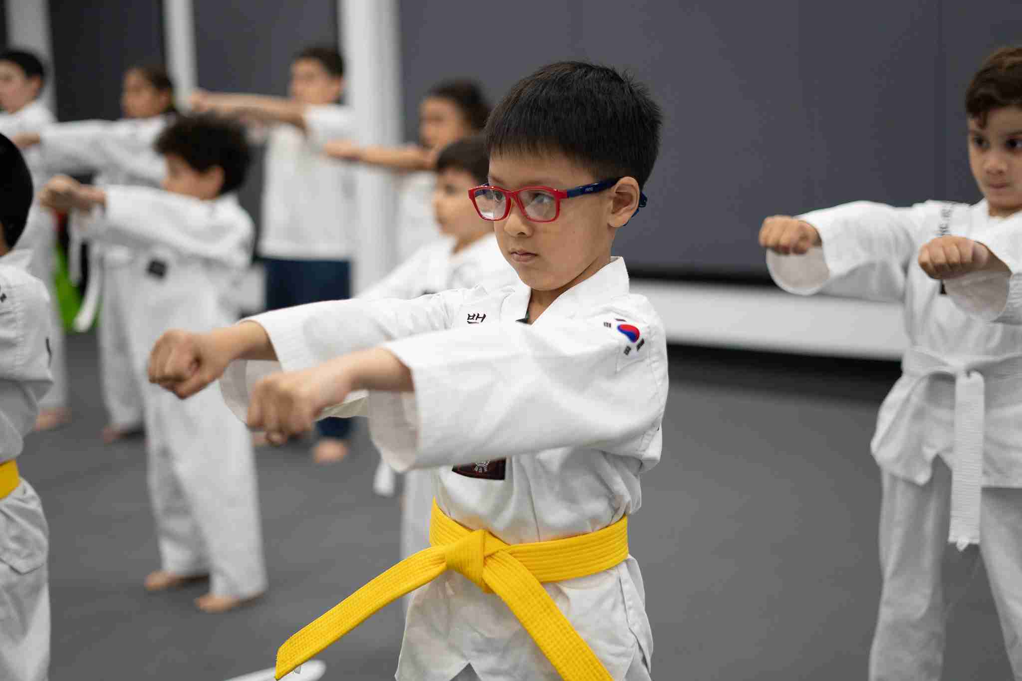 children practicing martial arts in Rego Park dojo