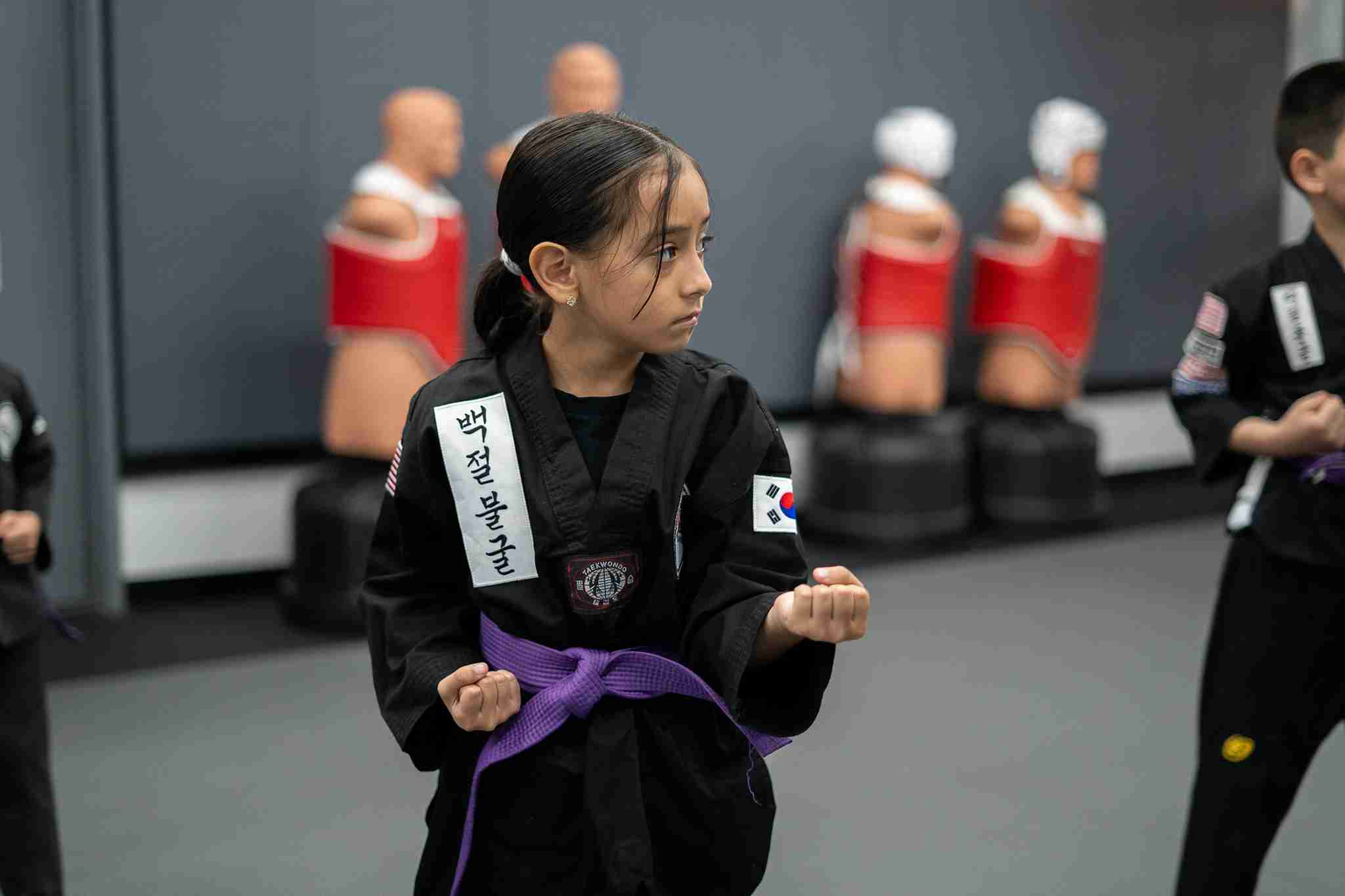 young martial artists earning belts and achieving goals