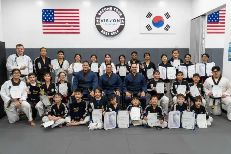 Martial arts academy group photo after taekwondo belt promotion ceremony