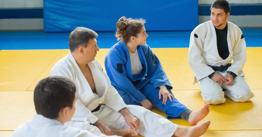 Adult students participating in group instruction during adult martial arts training sessions