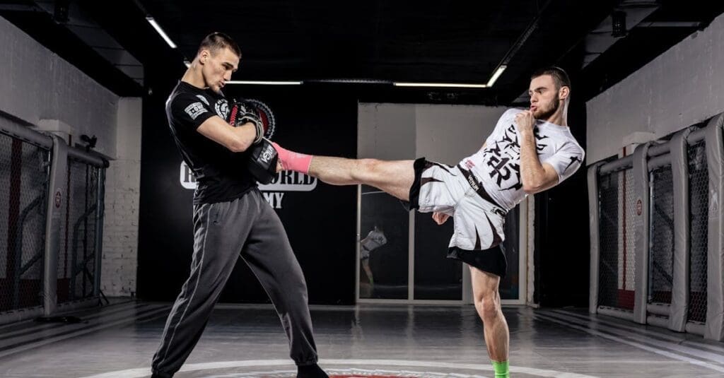 Adult martial artist performing a controlled kick drill during gym practice for martial arts training for adults