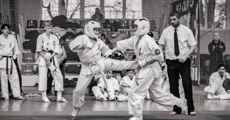 Adult students practicing sparring techniques during structured martial arts training for adults