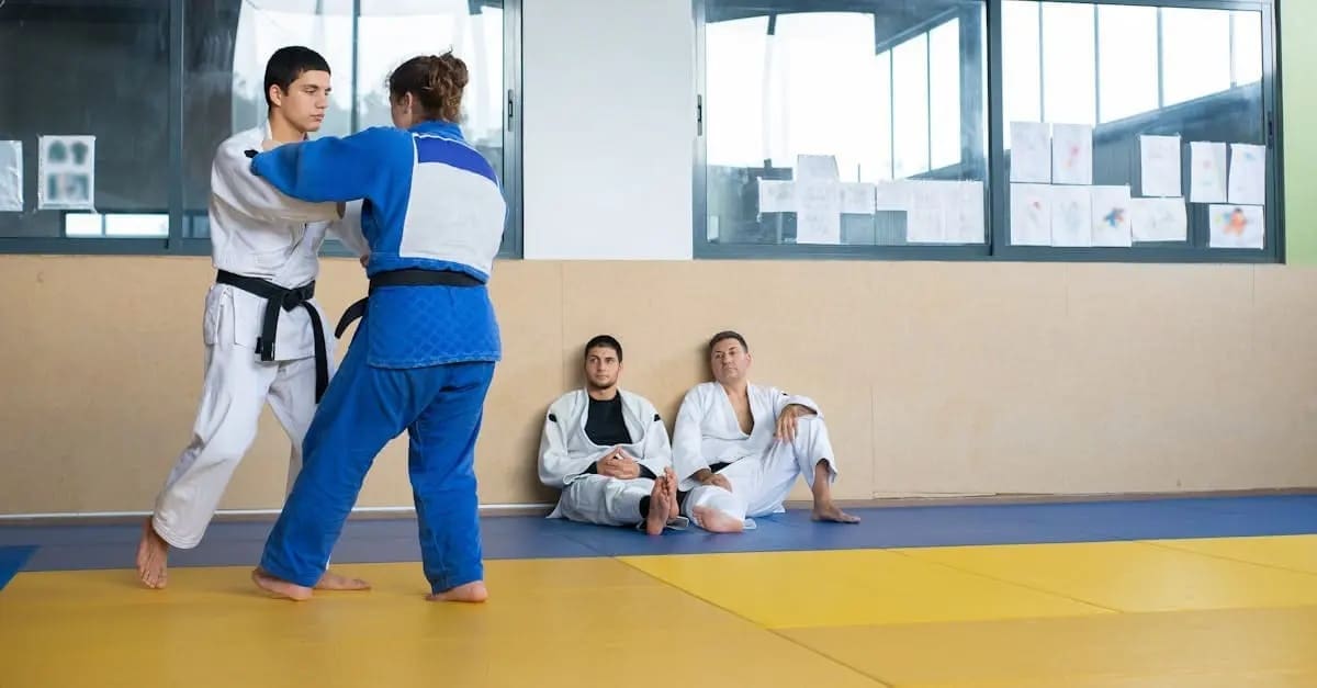 two black belt demonstrating self defense techniques for beginners in class while two students watch