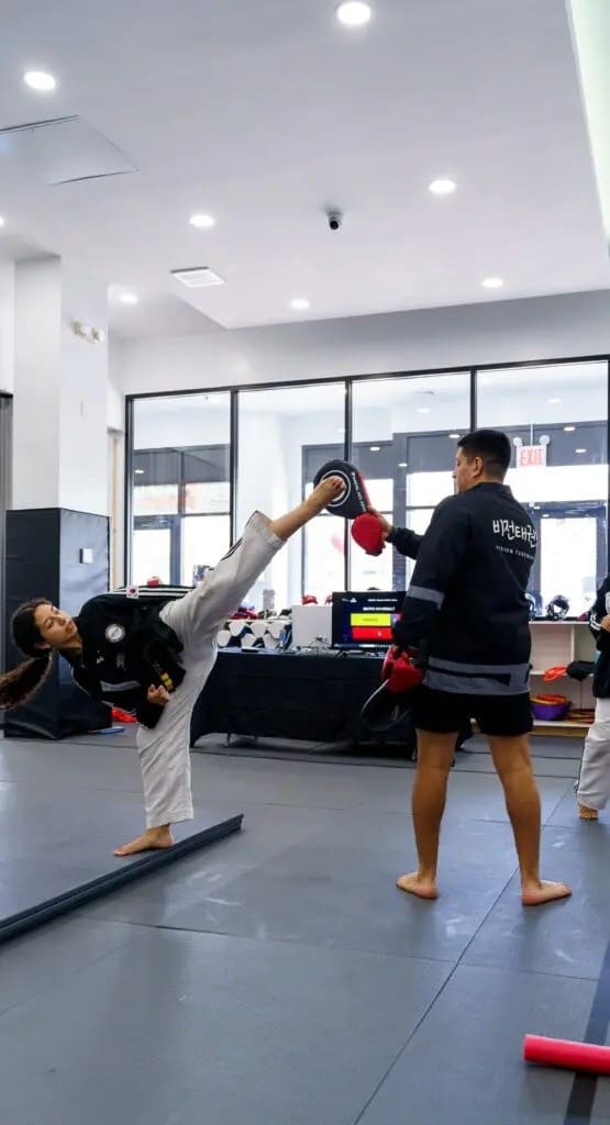 student doing high kick for teens taekwondo classes
